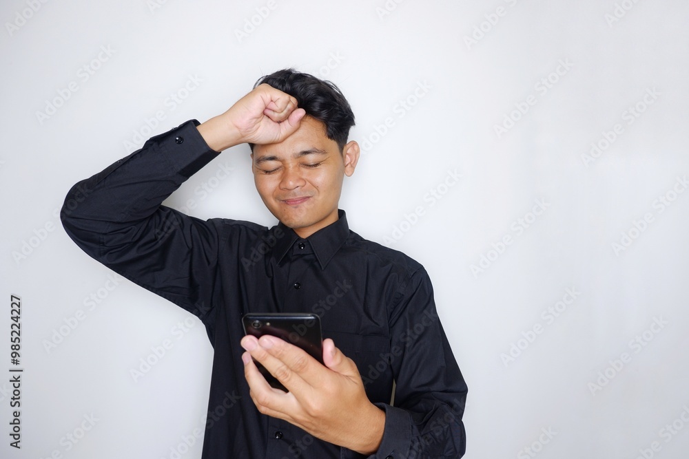 Portrait of a handsome Indonesian man wearing a plain black shirt with a random pose isolated on a white background Portrait of a handsome Indonesian man wearing a plain black shirt with a random pose isolated on a white background
