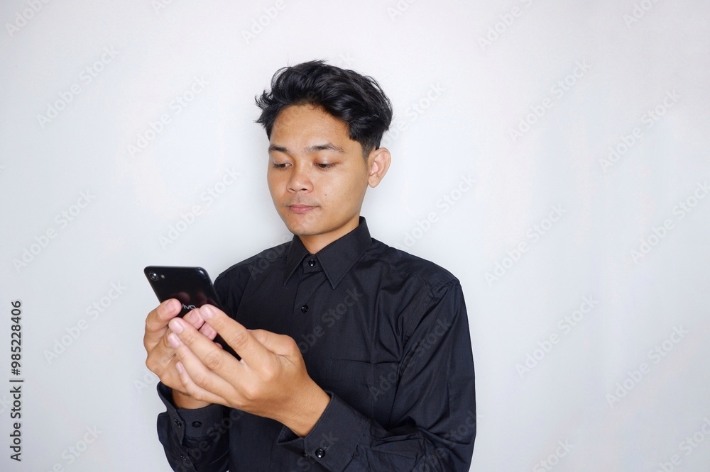 Portrait of a handsome Indonesian man wearing a plain black shirt with a random pose isolated on a white background Portrait of a handsome Indonesian man wearing a plain black shirt with a random pose isolated on a white background