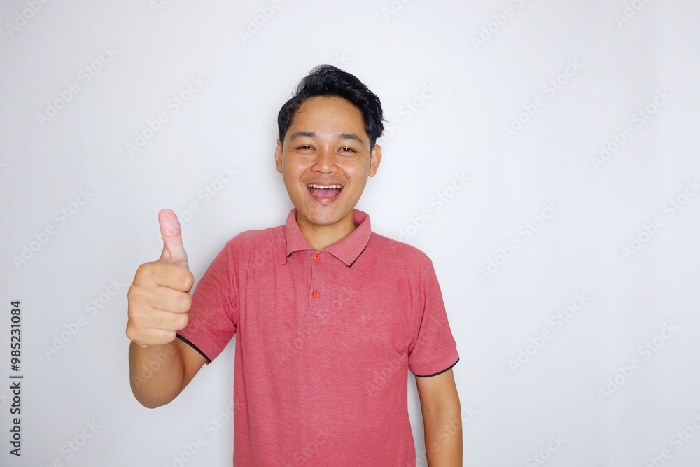 Random expression of Asian Indonesian adult man wearing red shirt isolated on white background Random expression of Asian Indonesian adult man wearing red shirt isolated on white background
