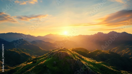Breathtaking sunrise over green mountains, showcasing vibrant colors and serene nature, perfect for landscapes and travel themes.