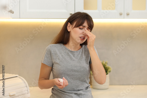 Tired woman suffering from sinusitis at home