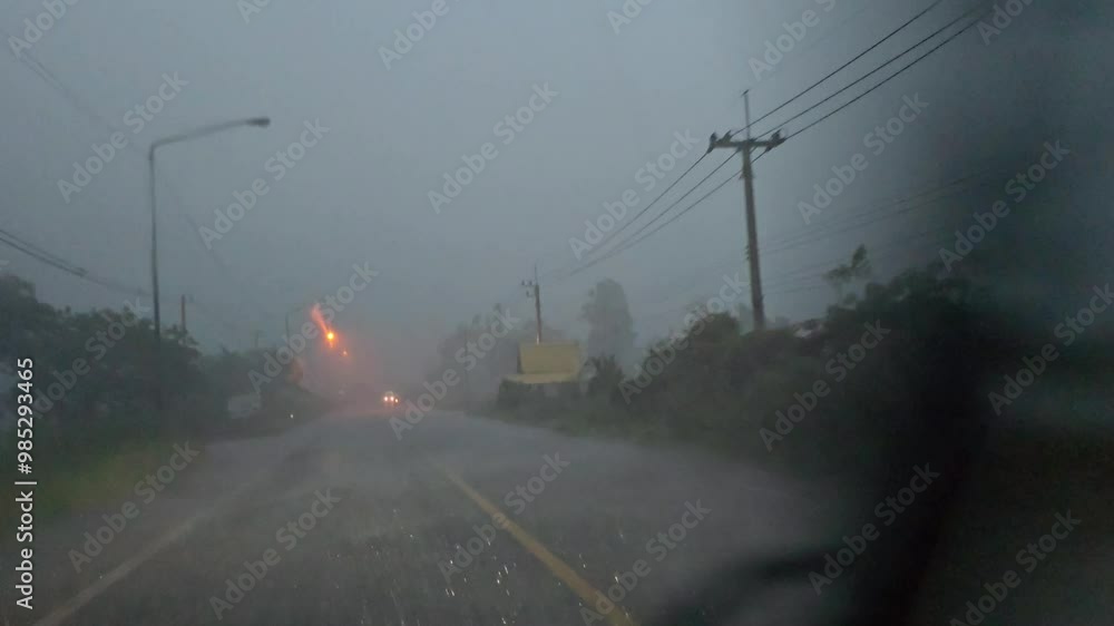 Driving in heavy rain on the road in rural, Lopburi, Thailand. Driving in heavy rain on the road in rural, Lopburi, Thailand.