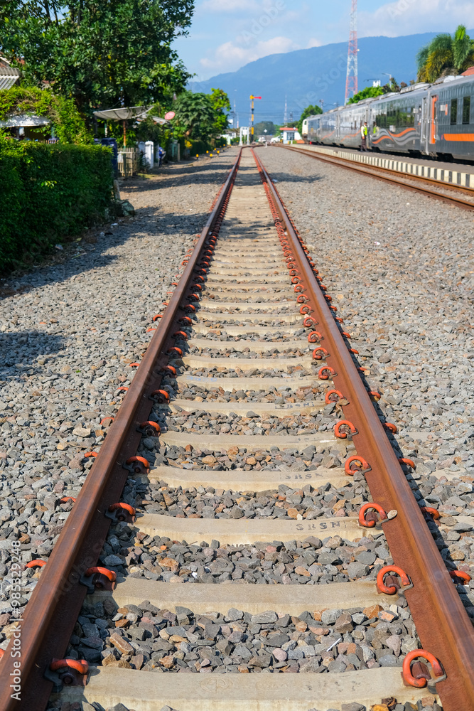 Fototapeta premium railway in the countryside, railroad tracks in the countryside, railway in Indonesia, train and railway, railway in the mountains, railway tracks, railway in the village, travel by train in Indonesia