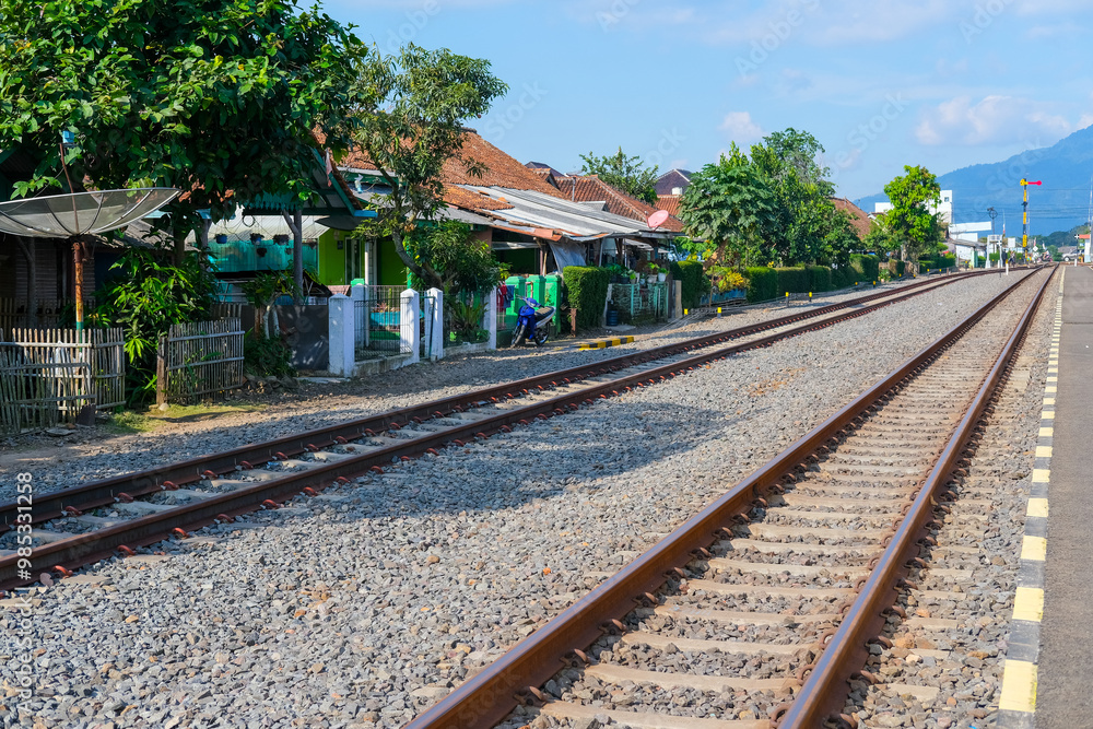Obraz premium railway in the countryside, railroad tracks in the countryside, railway in Indonesia, train and railway, railway in the mountains, railway tracks, railway in the village, travel by train in Indonesia