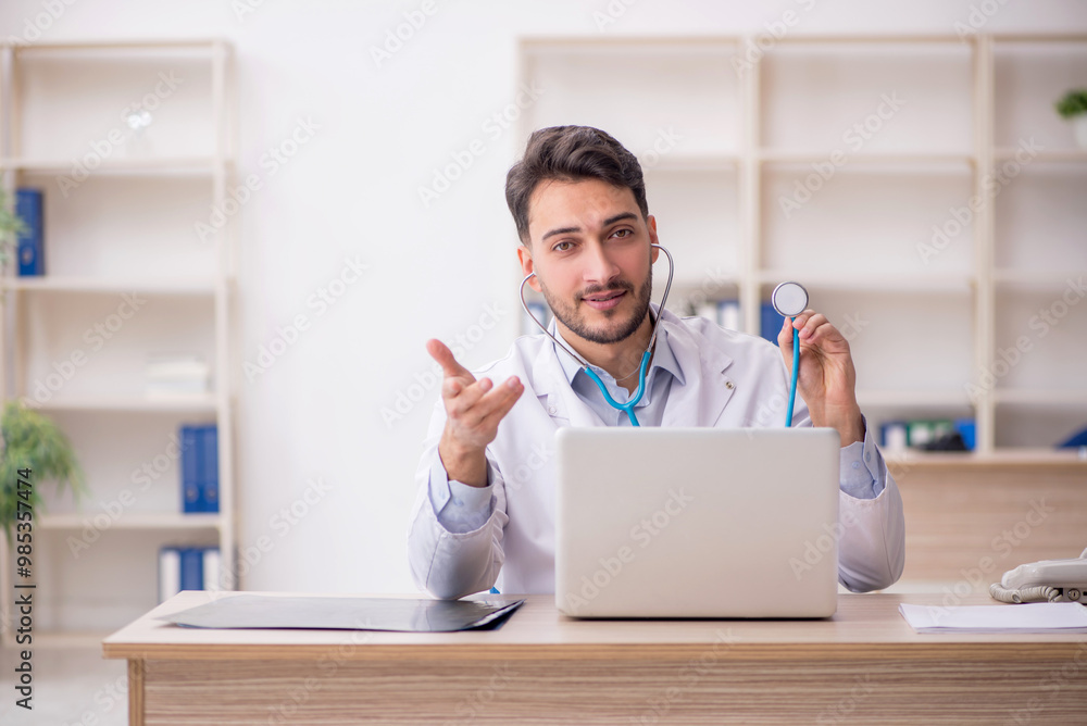 Young male doctor in telemedicine concept Young male doctor in telemedicine concept