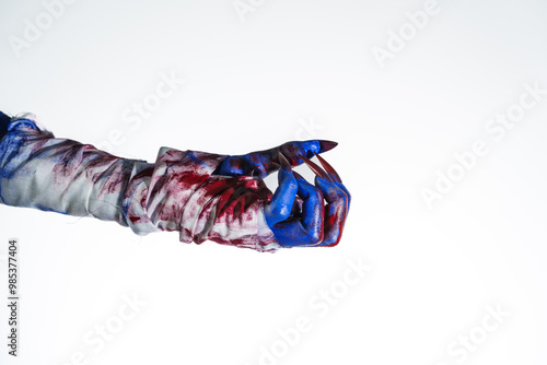 A blue witch hand with red nails, wrapped in a blood-stained bandage against a white background. This eerie, monstrous image evokes demonic, zombie, and ghostly vibes, perfect for Halloween horror.