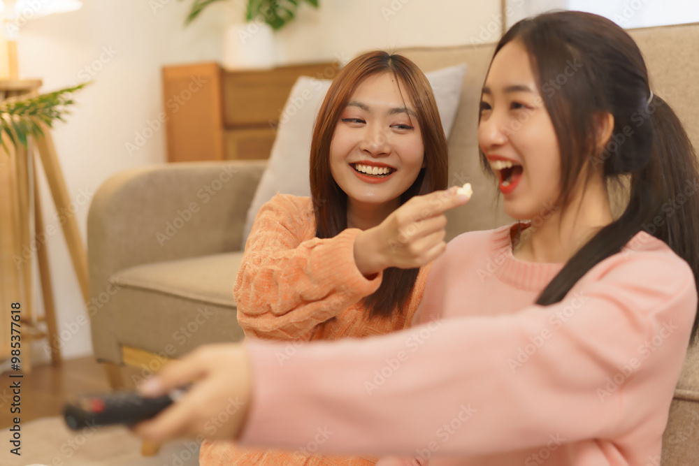 Friendship concept, LGBT lesbian couple feed popcorn to girlfriend while switching channels movie Friendship concept, LGBT lesbian couple feed popcorn to girlfriend while switching channels movie