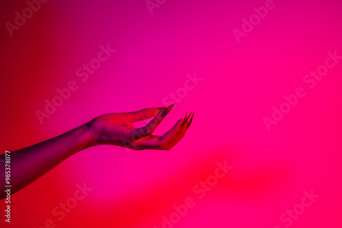 Photography A terrifying witch's hand with long red nails, resembling a demon or vampire