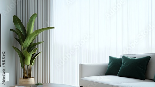 Bright and modern living room featuring a cozy sofa, decorative cushions, and a lush green plant near sheer curtains.