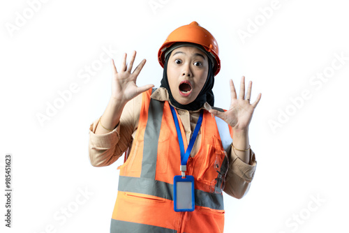 Young Asian female construction worker in hijab who looks shocked while looking at the camera, industrial and construction concept, isolated white background.