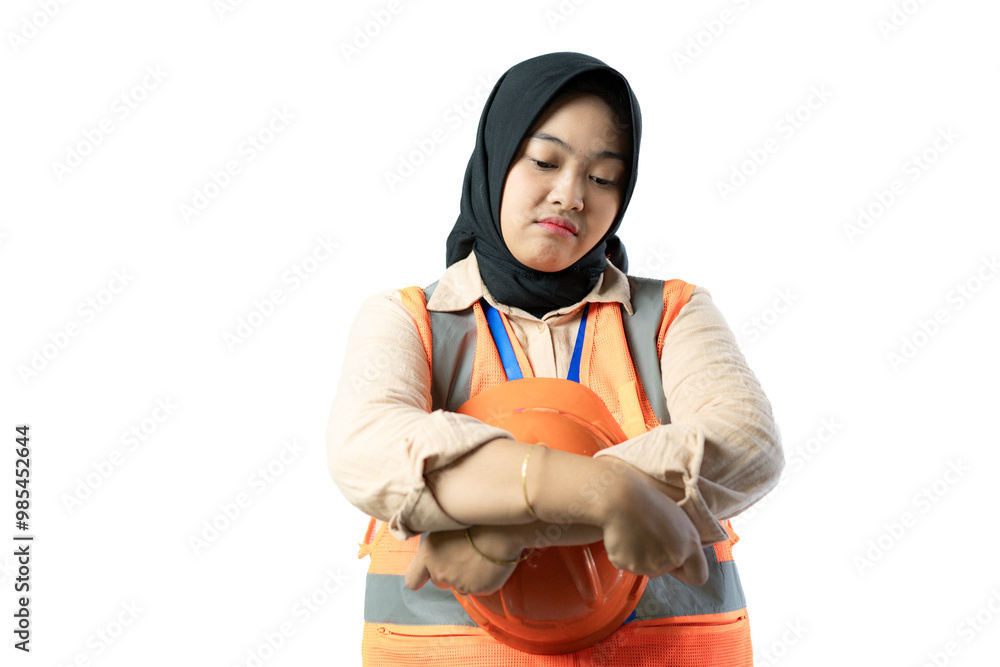 Young Asian female construction worker in hijab looks very angry and frustrated, industrial and construction concept, isolated white background. Young Asian female construction worker in hijab looks very angry and frustrated, industrial and construction concept, isolated white background.