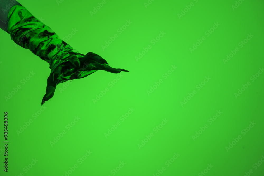A bloodied witch hand wrapped in bandages, set against a green fire background. This demonic hand blends elements of vampires,aliens, and ghosts, evoking a spooky, monstrous feel perfect Halloween A bloodied witch hand wrapped in bandages, set against a green fire background. This demonic hand blends elements of vampires,aliens, and ghosts, evoking a spooky, monstrous feel perfect Halloween