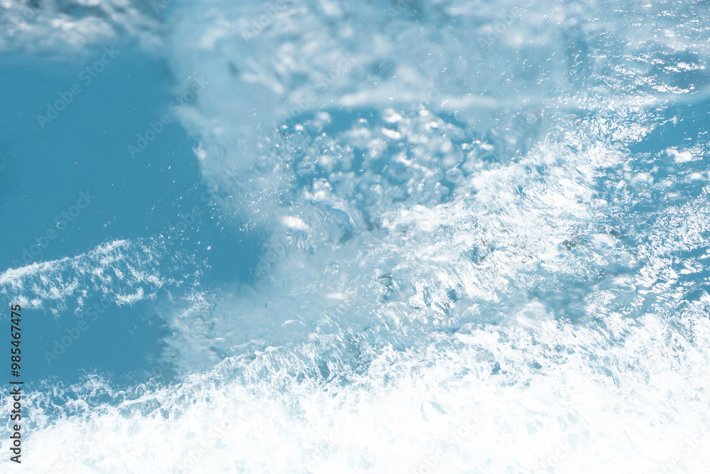 Blue water with ripples on the surface. Defocus blurred transparent blue colored clear calm water surface texture with splashes and bubbles. Water waves with shining pattern texture background. Blue water with ripples on the surface. Defocus blurred transparent blue colored clear calm water surface texture with splashes and bubbles. Water waves with shining pattern texture background.