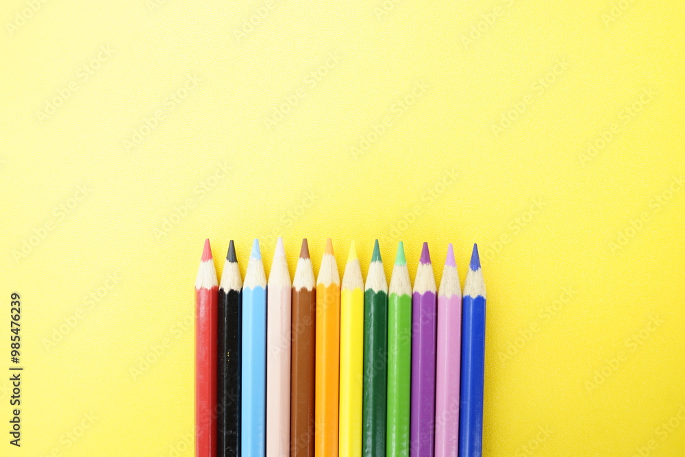 Colorful Pencils on Yellow Background Colorful Pencils on Yellow Background