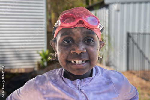 Aboriginal girl with swimming cap and goggles photo