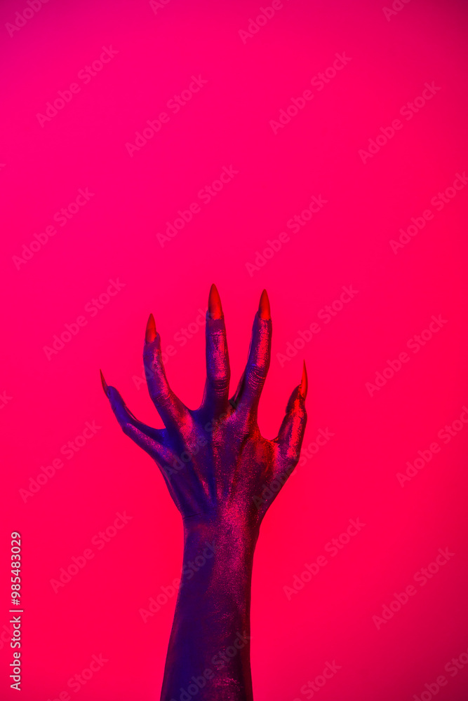 A witch hand with long nails appears against a red fire background, evoking a demonic, monstrous presence. Blending vampire, alien, ghost, and zombie elements, it perfectly embodies Halloween A witch hand with long nails appears against a red fire background, evoking a demonic, monstrous presence. Blending vampire, alien, ghost, and zombie elements, it perfectly embodies Halloween
