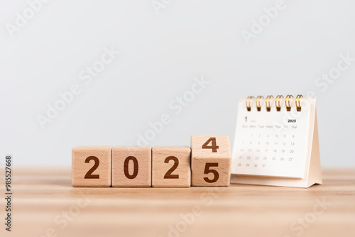 Flipping wooden cube from 2024 to 2025. Happy new year Calendar 2025. New year resolution, goal, plan, and action concept. target plan and mission annual. background and banner photo