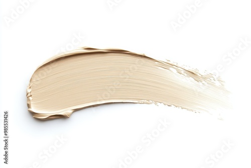 A smooth, creamy swatch of foundation makeup on a white background.