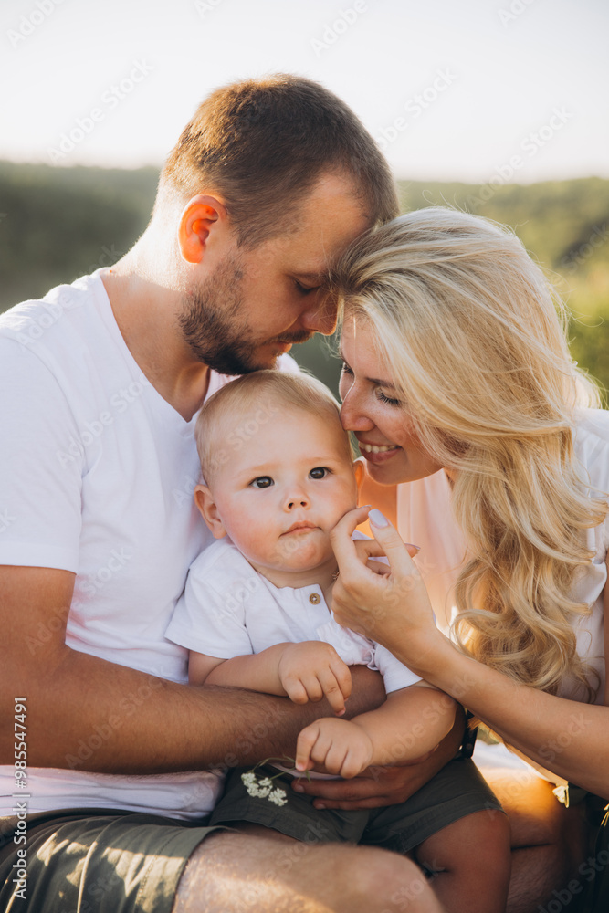 Happy Family Enjoys Quality Time Outdoors in Sunlit Natural Setting Happy Family Enjoys Quality Time Outdoors in Sunlit Natural Setting