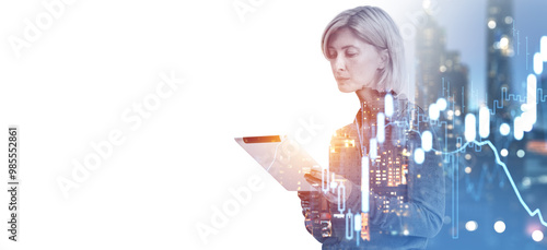 Businesswoman analyzing financial data with a tablet in a citysc photo