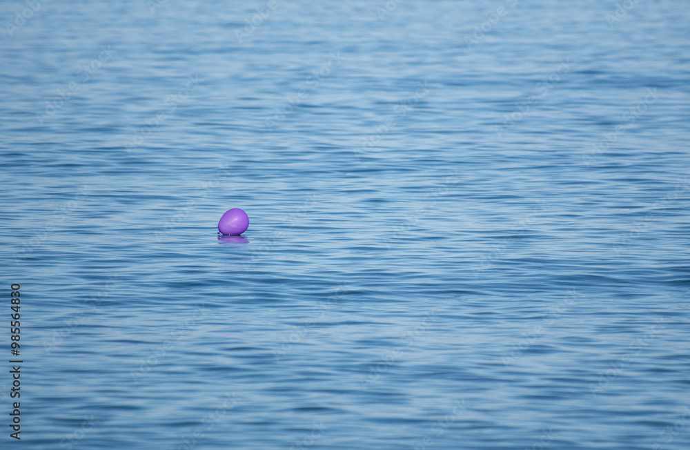 A purple balloon is floating in the ocean A purple balloon is floating in the ocean