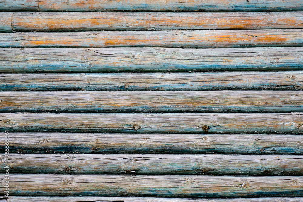 The image is of a wooden wall with a blue and white pattern The image is of a wooden wall with a blue and white pattern
