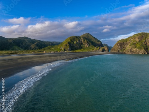 Ocean coastline at the Manuka Harbour entrance. Surrounded by cliffs and hills in the Waitakere ranges. Whatipu, Auckland, New Zealand.