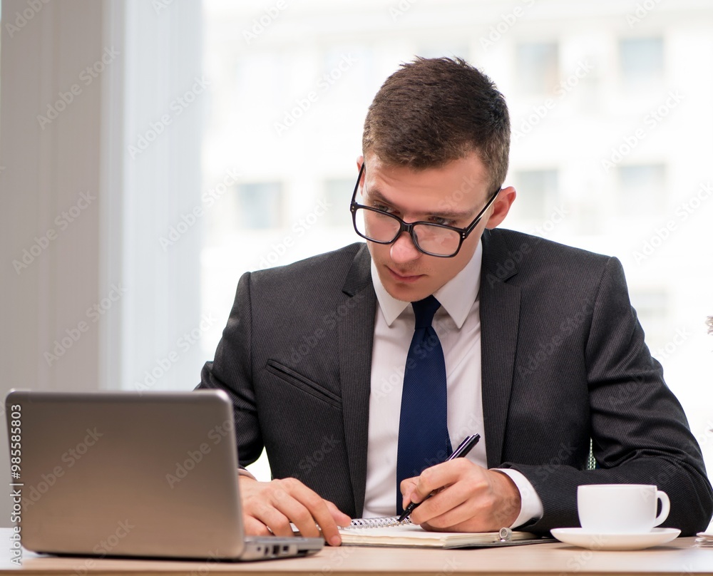 Young businessman drinking tea in the office Young businessman drinking tea in the office