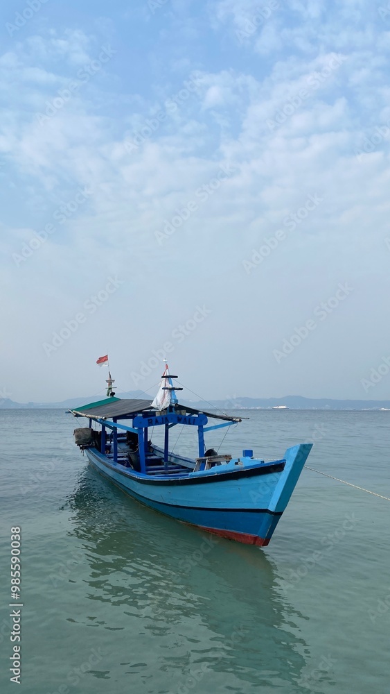 Bandar Lampung, Indonesia - September 1st 2024: Fishing boats are parked on the seashore in the afternoon with a cloudy sky in the background Bandar Lampung, Indonesia - September 1st 2024: Fishing boats are parked on the seashore in the afternoon with a cloudy sky in the background
