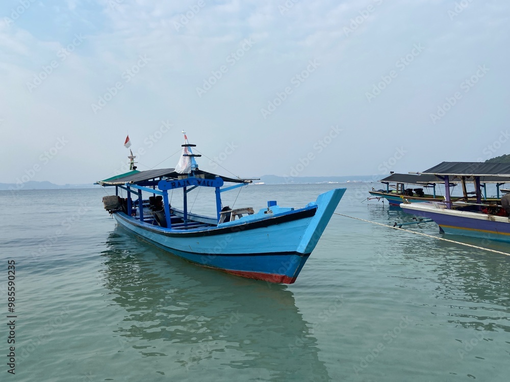 Bandar Lampung, Indonesia - September 1st 2024: Fishing boats are parked on the seashore in the afternoon with a cloudy sky in the background Bandar Lampung, Indonesia - September 1st 2024: Fishing boats are parked on the seashore in the afternoon with a cloudy sky in the background