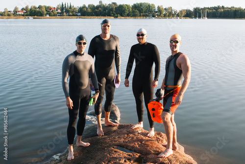 Swedish men stood on a rock ready to swim in the baltic sea photo