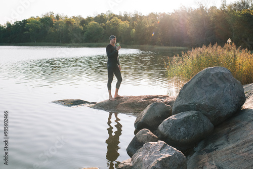 Scandinavian man drinking tea after swimming in the sea photo