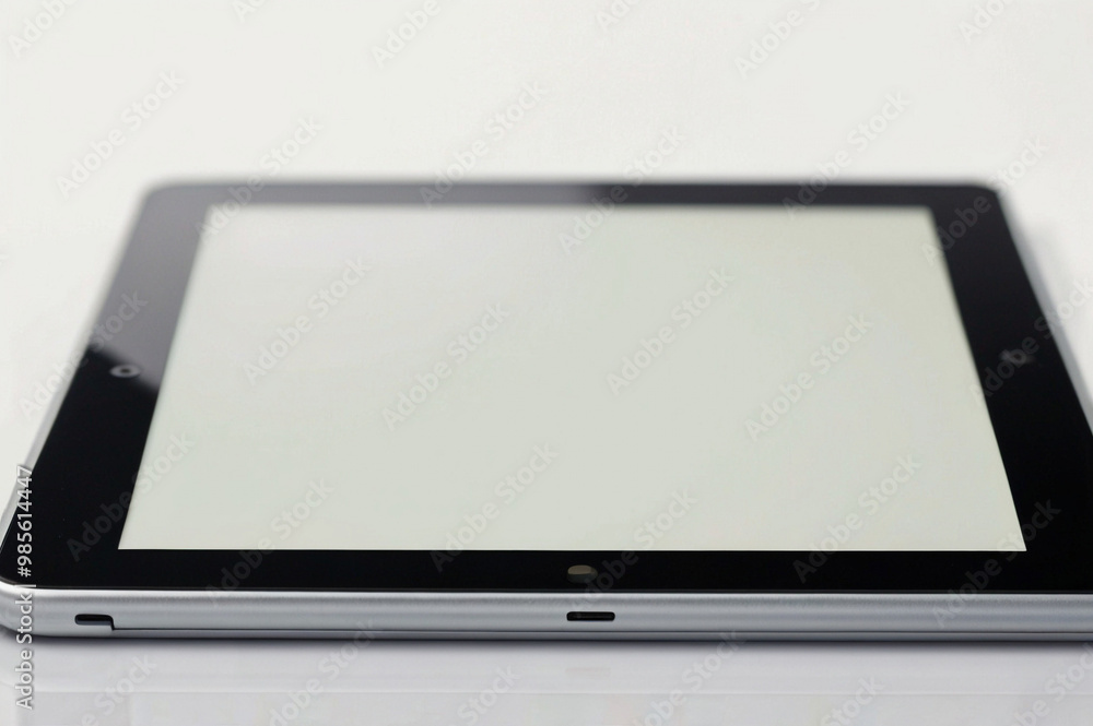 Digital Tablet with Blank Screen on White Surface Digital Tablet with Blank Screen on White Surface