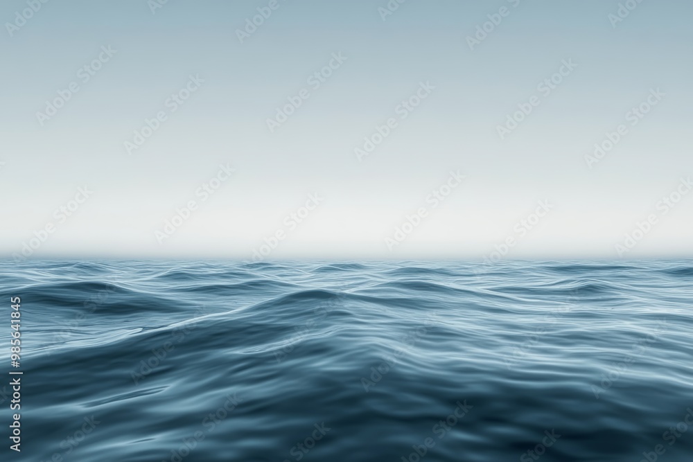 Obraz premium Gentle waves roll across the ocean surface as early morning light casts a serene glow, creating a peaceful and tranquil atmosphere