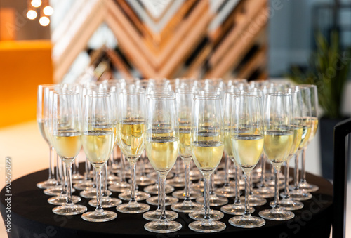 Welcome glasses of champagne waiting to be served and drunk by guests celebrating an important event at a banquet photo