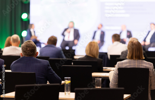 Rear view of the audience at a business conference meeting event listening to the speakers speech photo