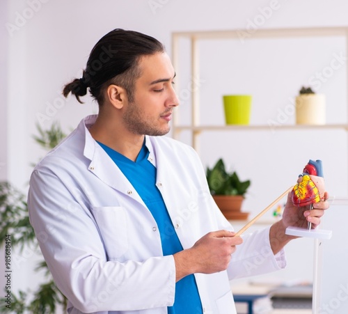 Young male doctor in presentation concept