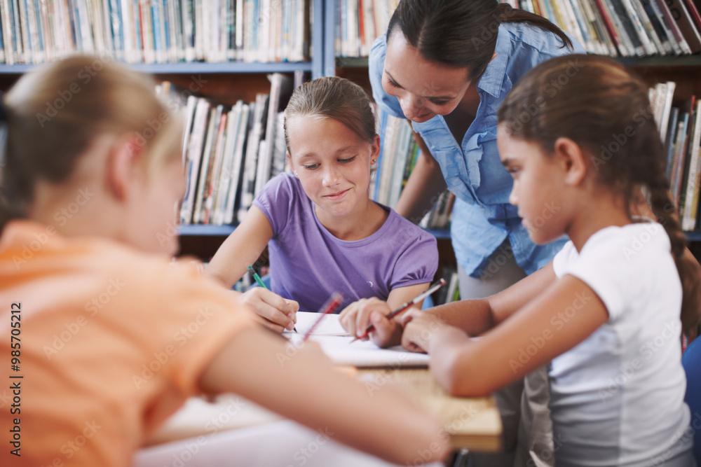 Exam, teacher and student with questions in a classroom or library for learning development. Education, kids and children asking help from woman with smile and support for assignment at school Exam, teacher and student with questions in a classroom or library for learning development. Education, kids and children asking help from woman with smile and support for assignment at school