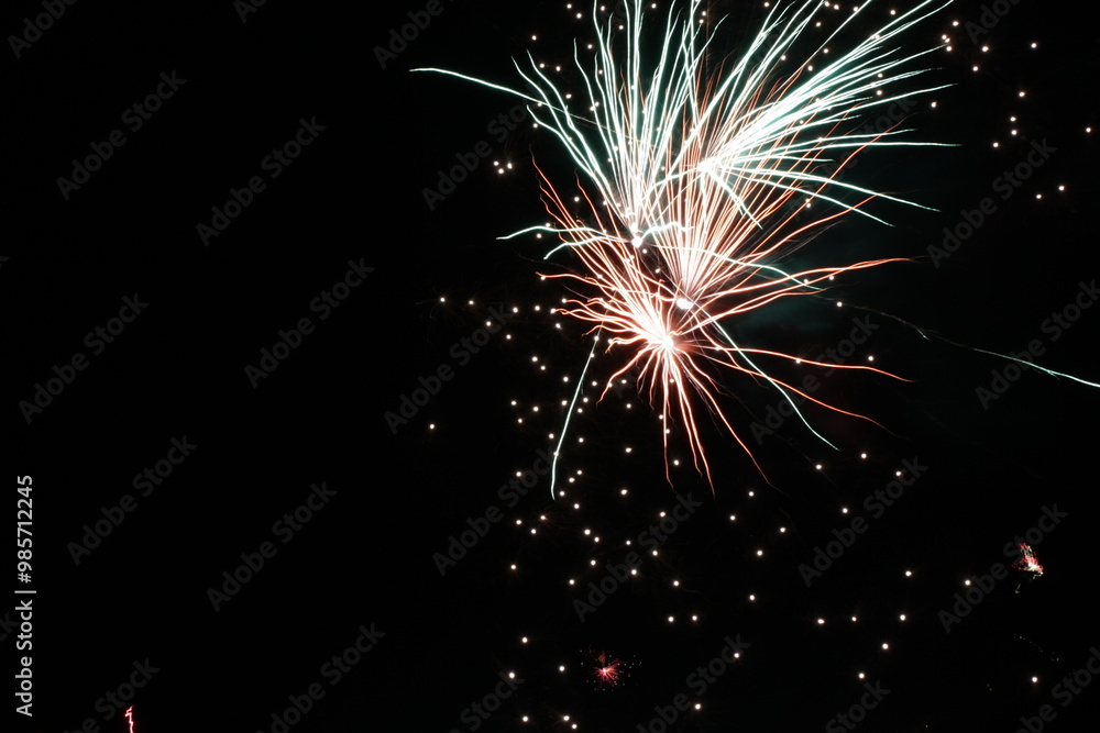New Year's Eve firework in the dark sky | Series with colorful high contrast flares New Year's Eve firework in the dark sky | Series with colorful high contrast flares