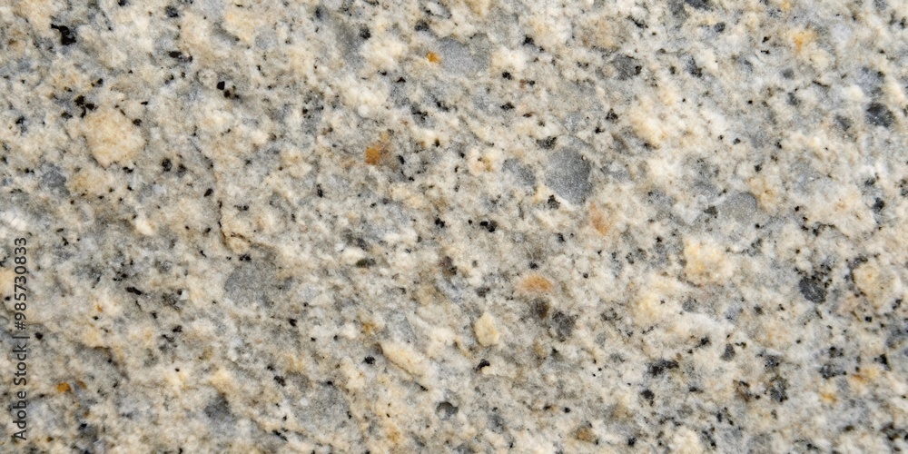 Close up of gray natural stone texture with rough surface and dark speckles Close up of gray natural stone texture with rough surface and dark speckles