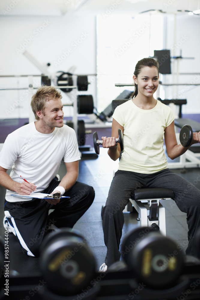 Personal trainer, clipboard and people with workout in gym for ...