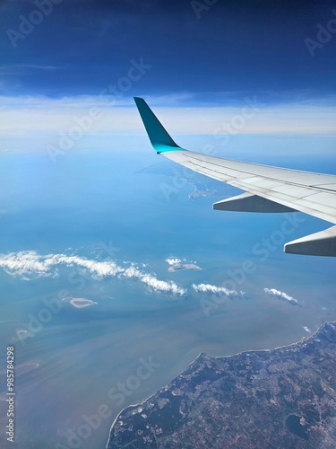 view land and sea from airplane window photo