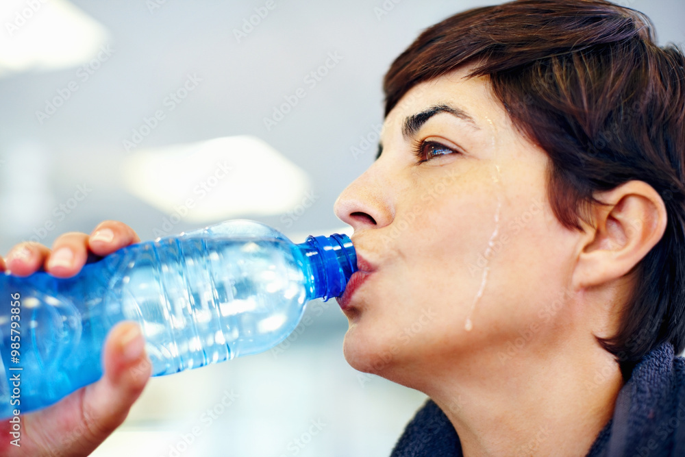 Fitness, sweat or woman drinking water for health, wellness or nutrition with face profile in gym. Tired, liquid or thirsty athlete with bottle for hydration on break after exercise, sport or workout Fitness, sweat or woman drinking water for health, wellness or nutrition with face profile in gym. Tired, liquid or thirsty athlete with bottle for hydration on break after exercise, sport or workout
