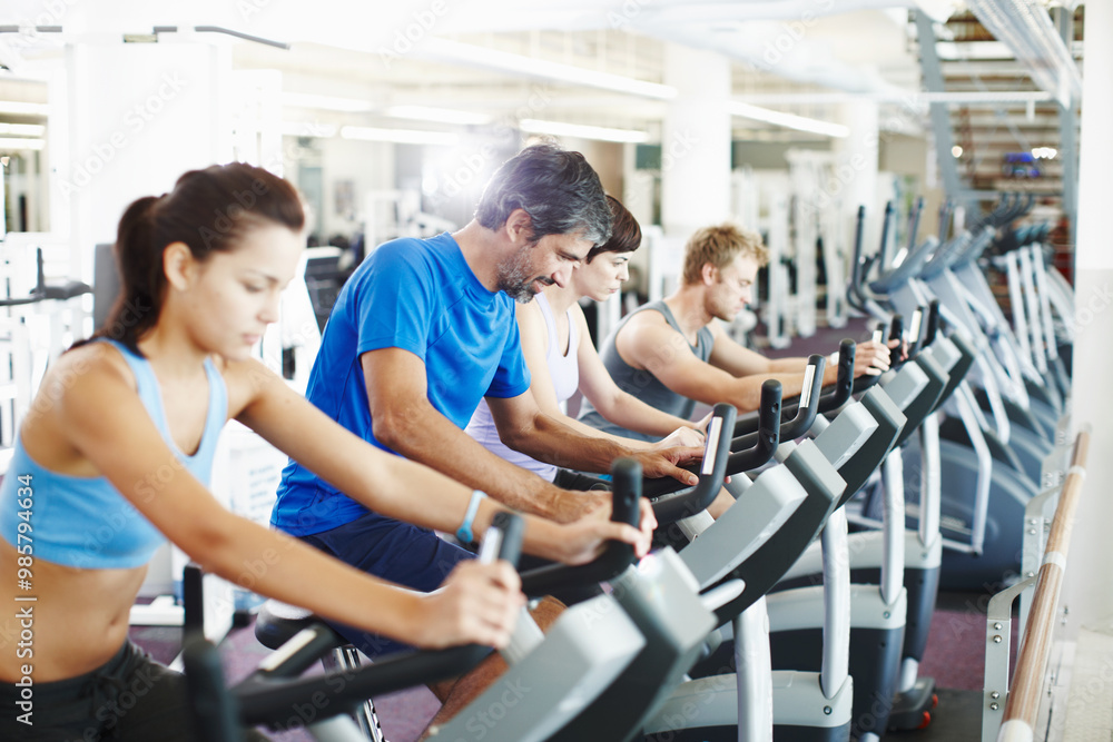 Group, spin class or mature man on cycling machine in training or exercise for wellness or fitness. Active club, healthy or people on bicycle for cardio, power for workout, body or sports on bike Group, spin class or mature man on cycling machine in training or exercise for wellness or fitness. Active club, healthy or people on bicycle for cardio, power for workout, body or sports on bike