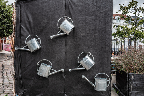 Watering cans in a city garden in Viborg, Denmark photo