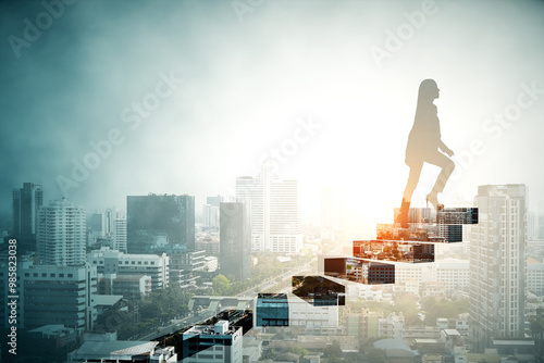 Silhouette of a woman walking up steps over a city skyline at sunrise, symbolizing career growth and ambition.
