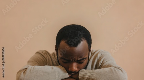 Thoughtful Man Resting His Head on Arms