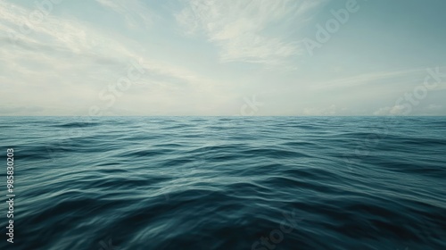 A wide shot of a calm ocean, with gentle waves rolling towards a distant horizon.