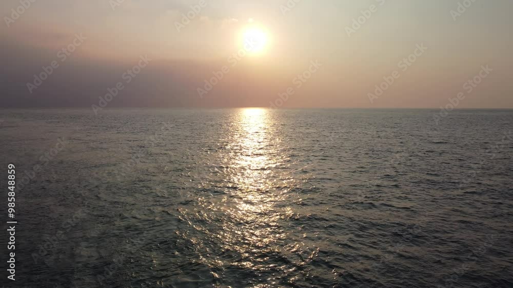 Amazing sunset view on the sea. Beautiful tropical beach with sunrise sky. The beautiful Anyer Beach is a famous tourist destination in the Indian Ocean summer. Amazing sunset view on the sea. Beautiful tropical beach with sunrise sky. The beautiful Anyer Beach is a famous tourist destination in the Indian Ocean summer.