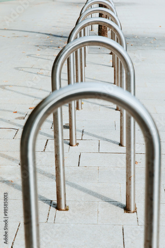 Bicycle racks, urban bike parking, modern metal stands, city street infrastructure, transportation concept